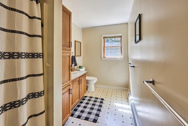 bathroom with crown molding, vanity, tile patterned floors, baseboards, and toilet