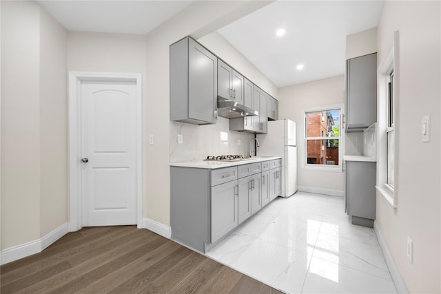 61-12 160th St, Fresh Meadows, NY 11365 - kitchen featuring gray cabinets, under cabinet range hood, light countertops, stainless steel gas stovetop, and recessed lighting