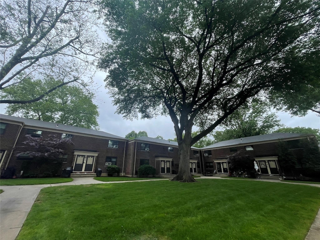 22048 75th Ave Unit A1, Bayside, NY 11364 - view of grassy yard featuring entry steps and french doors