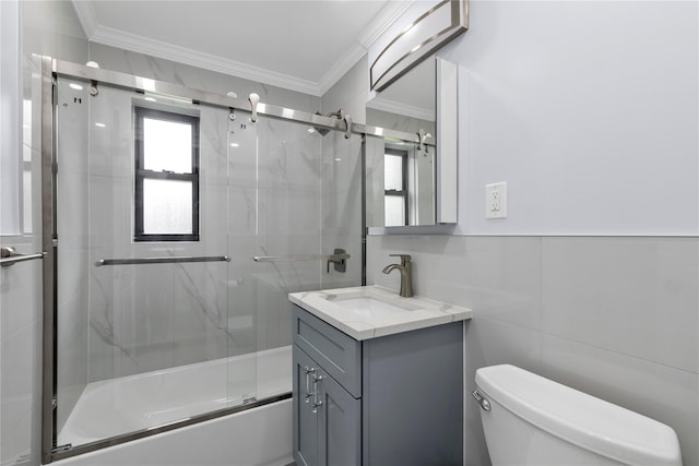 22048 75th Ave Unit A1, Bayside, NY 11364 - full bath with crown molding, toilet, vanity, shower / bath combination with glass door, and tile walls