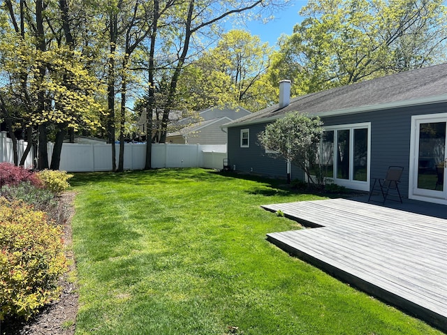 view of yard with fence and a wooden deck