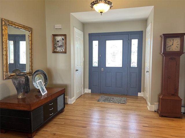 entrance foyer with baseboards and light wood-style floors