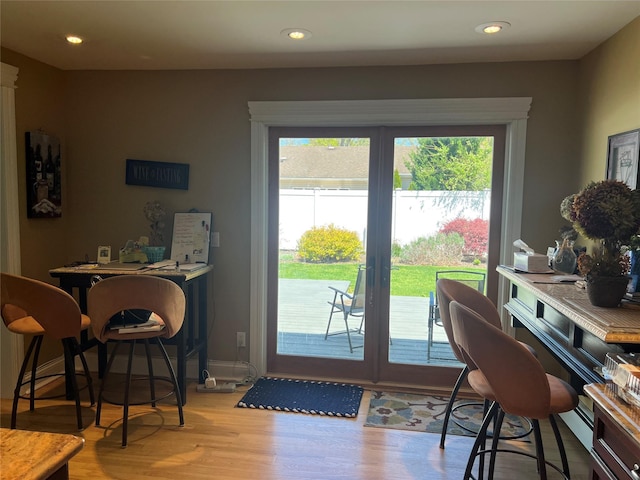 doorway to outside featuring recessed lighting, baseboards, wood finished floors, and french doors