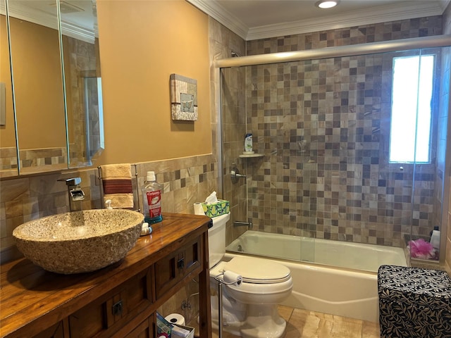 full bathroom featuring enclosed tub / shower combo, tile walls, vanity, toilet, and ornamental molding