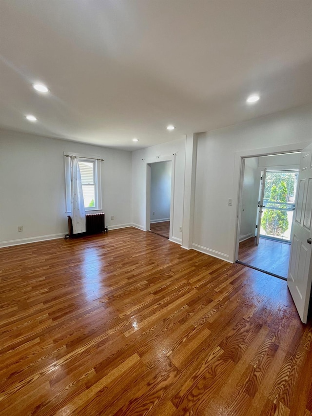 58 7th St, Valley Stream, NY 11581 - unfurnished room featuring radiator, wood finished floors, and recessed lighting