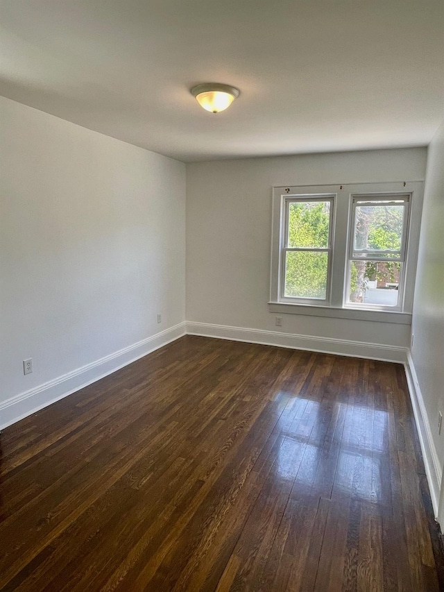 58 7th St, Valley Stream, NY 11581 - spare room featuring dark wood-type flooring and baseboards