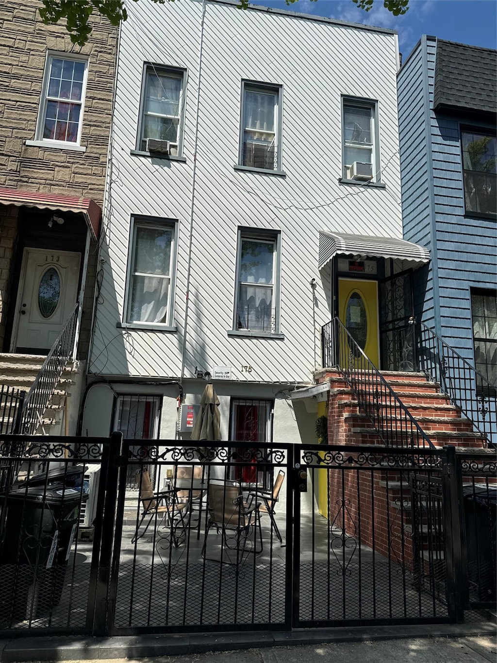 multi unit property with cooling unit and a fenced front yard