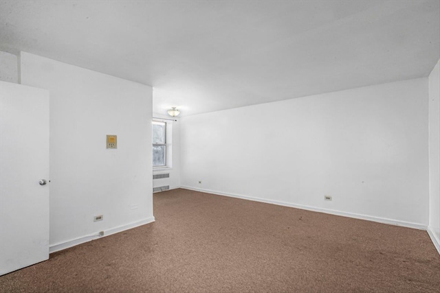 unfurnished room with radiator heating unit, baseboards, and carpet