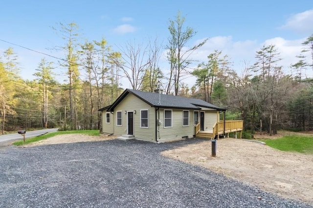 435 State Route 55, Eldred, NY 12732 - view of front of house with gravel driveway, roof with shingles, and a deck