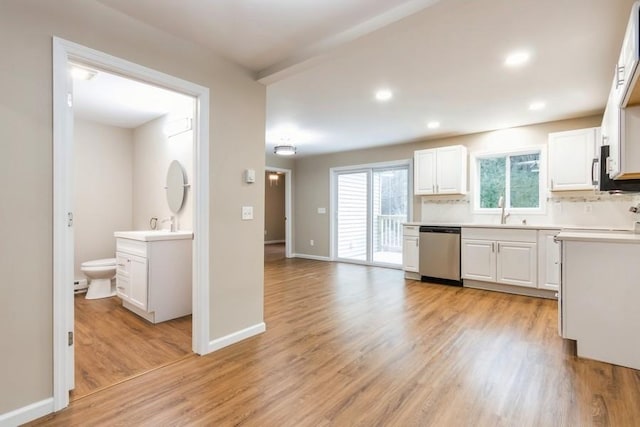 435 State Route 55, Eldred, NY 12732 - kitchen with white cabinets, a sink, light wood-style floors, light countertops, and stainless steel dishwasher