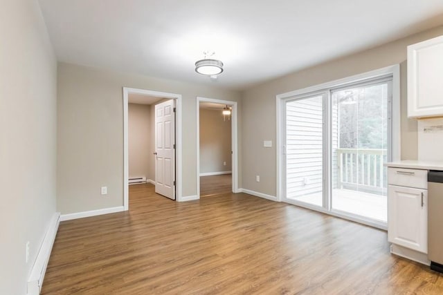 435 State Route 55, Eldred, NY 12732 - unfurnished dining area with baseboards, baseboard heating, light wood-style flooring, and a baseboard radiator