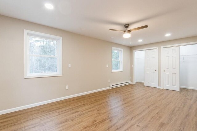 435 State Route 55, Eldred, NY 12732 - unfurnished bedroom with multiple closets, baseboards, baseboard heating, recessed lighting, and light wood finished floors