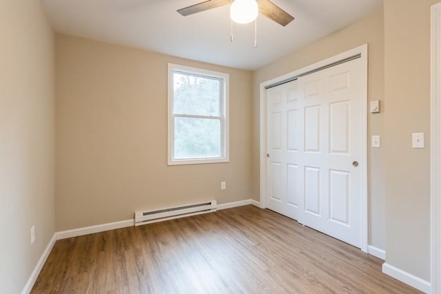 435 State Route 55, Eldred, NY 12732 - unfurnished bedroom featuring baseboards, a baseboard radiator, a closet, and light wood finished floors