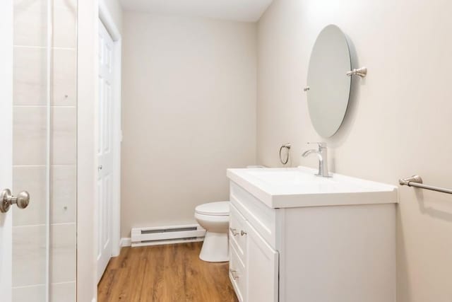435 State Route 55, Eldred, NY 12732 - bathroom with vanity, a baseboard radiator, toilet, and wood finished floors