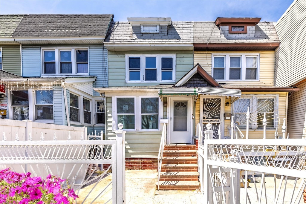 30-38 91st St, East Elmhurst, NY 11369 - townhome / multi-family property featuring fence