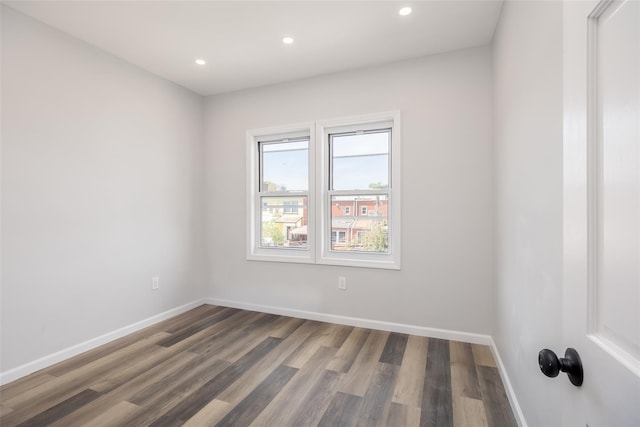 unfurnished room featuring baseboards, recessed lighting, and wood finished floors