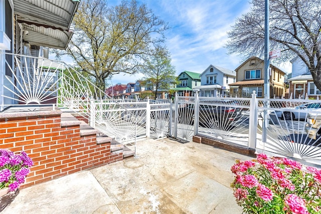 view of patio with a residential view and fence