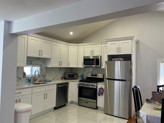 kitchen with light countertops, a sink, white cabinets, and stainless steel appliances