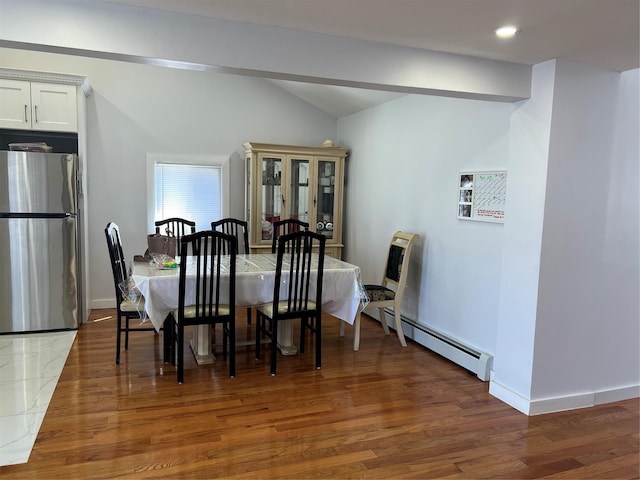 dining room featuring wood finished floors, baseboards, a baseboard heating unit, lofted ceiling, and recessed lighting