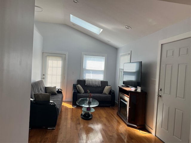 living room featuring recessed lighting, lofted ceiling with skylight, and wood finished floors