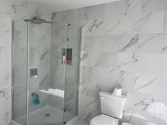 bathroom with toilet, tile walls, and a stall shower