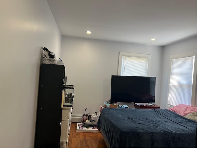 bedroom with recessed lighting and wood finished floors