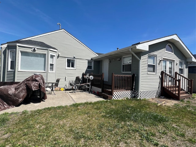 back of house featuring a yard and a patio