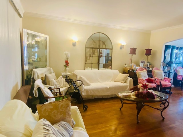 living area with crown molding and wood finished floors