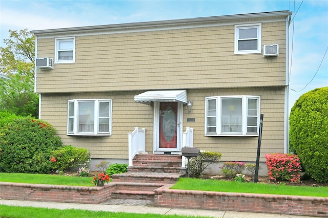 colonial home with a wall unit AC