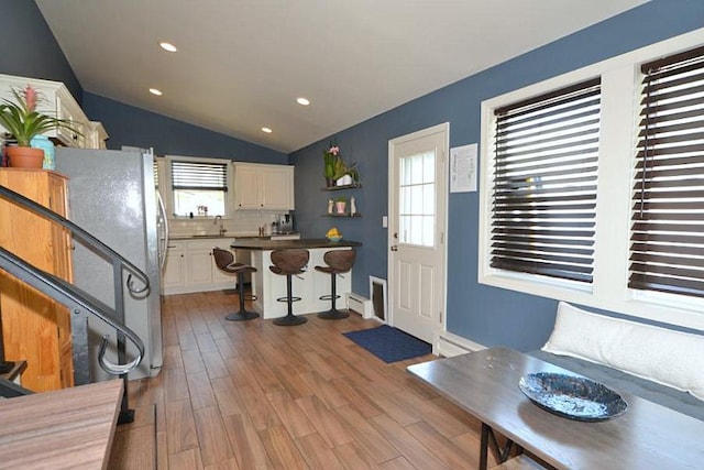 127 W Court Dr, Centereach, NY 11720 - foyer featuring light wood-style floors, vaulted ceiling, plenty of natural light, and recessed lighting