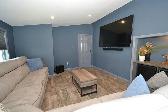 127 W Court Dr, Centereach, NY 11720 - living area with wood finished floors, baseboards, vaulted ceiling, and recessed lighting