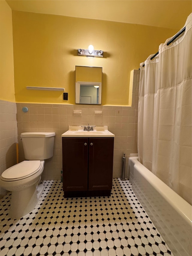 91 Tulip Ave Unit C2, Floral Park, NY 11001 - full bathroom featuring tile walls, tile patterned flooring, and a wainscoted wall