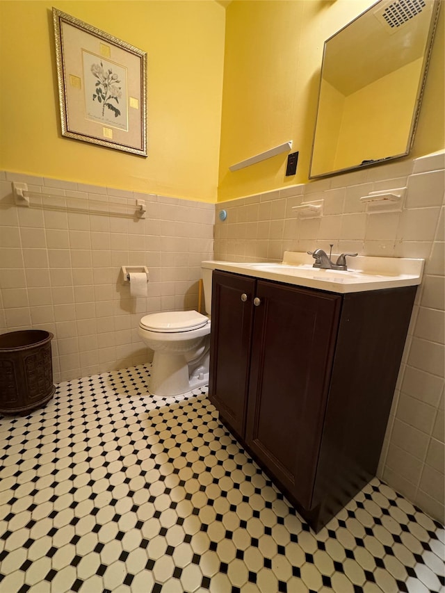 91 Tulip Ave Unit C2, Floral Park, NY 11001 - bathroom featuring vanity, wainscoting, toilet, and tile walls