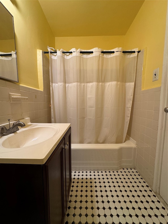 91 Tulip Ave Unit C2, Floral Park, NY 11001 - bathroom featuring tile patterned flooring, vanity, shower / bath combo with shower curtain, a wainscoted wall, and tile walls