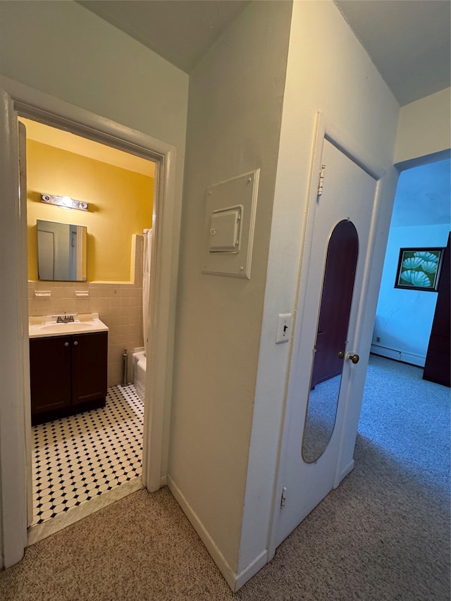 91 Tulip Ave Unit C2, Floral Park, NY 11001 - corridor featuring baseboards, light carpet, a sink, and electric panel