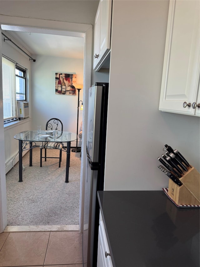 91 Tulip Ave Unit C2, Floral Park, NY 11001 - kitchen featuring white cabinets, cooling unit, carpet, freestanding refrigerator, and a baseboard heating unit