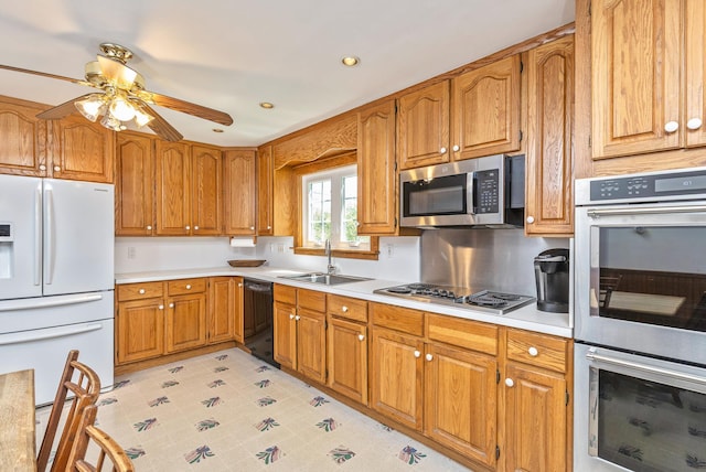8 Parkside Ave, Miller Place, NY 11764 - kitchen with a sink, appliances with stainless steel finishes, brown cabinetry, and light countertops