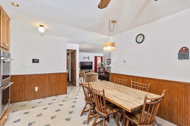 8 Parkside Ave, Miller Place, NY 11764 - dining space featuring wooden walls, ceiling fan, and wainscoting