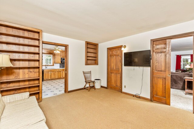 8 Parkside Ave, Miller Place, NY 11764 - unfurnished room with a ceiling fan, baseboards, light carpet, and a sink