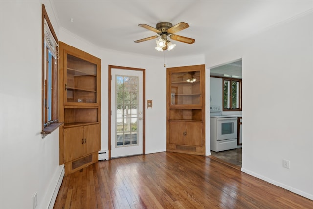 interior space with wood-type flooring, ceiling fan, a baseboard heating unit, and built in shelves