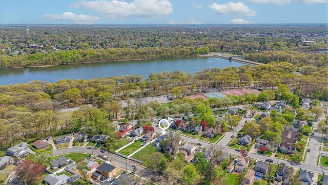 birds eye view of property with a water view and a residential view