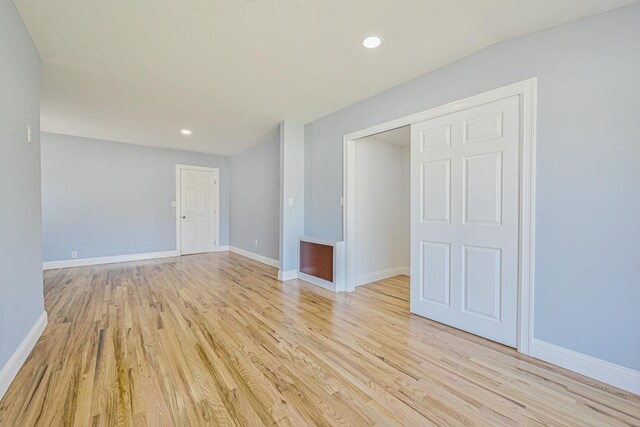 unfurnished room with recessed lighting, baseboards, and light wood-style floors