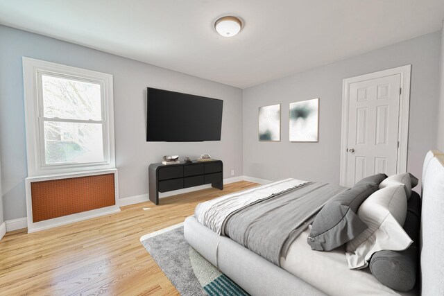 bedroom with baseboards and light wood-style flooring