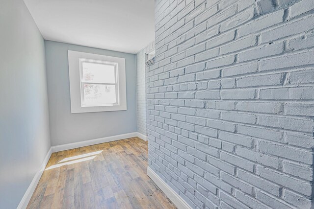 corridor with baseboards and hardwood / wood-style flooring