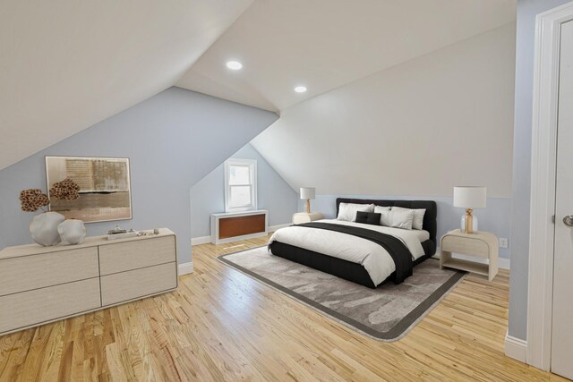 bedroom with baseboards, recessed lighting, wood finished floors, and vaulted ceiling