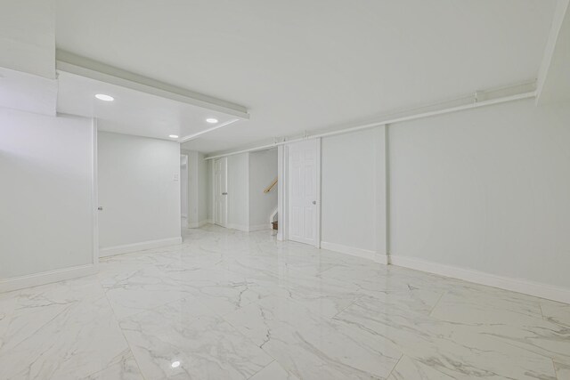finished basement featuring stairs, recessed lighting, baseboards, and marble finish floor