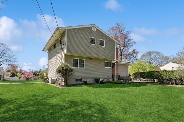 rear view of house with a lawn