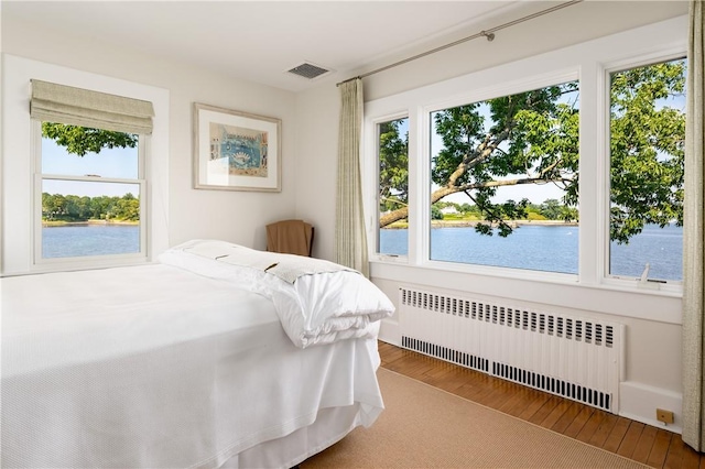 0 Rich, Greenwich, CT 06830 - bedroom with radiator heating unit, a water view, wood finished floors, and visible vents
