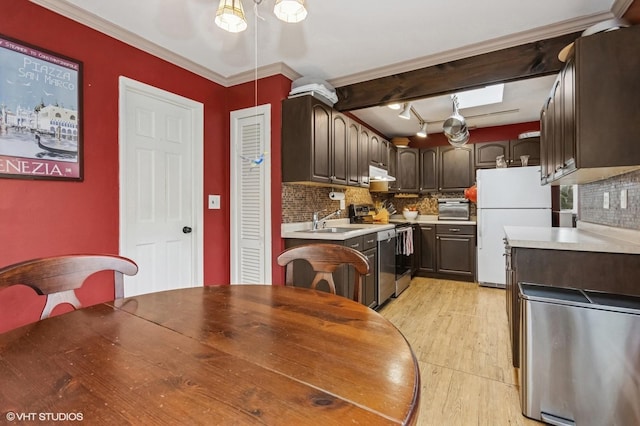 dining area with crown molding and light wood-style flooring