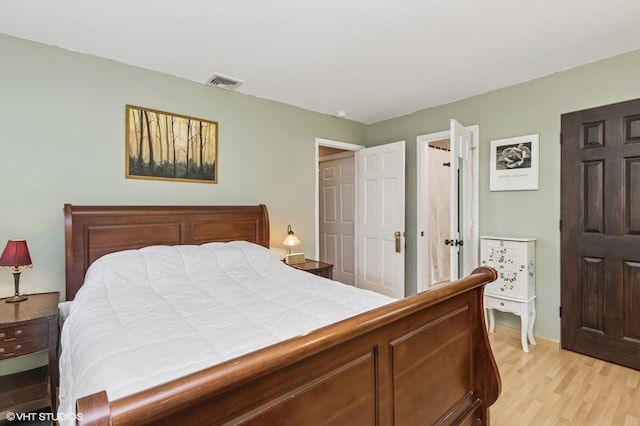 bedroom with visible vents and light wood-style floors